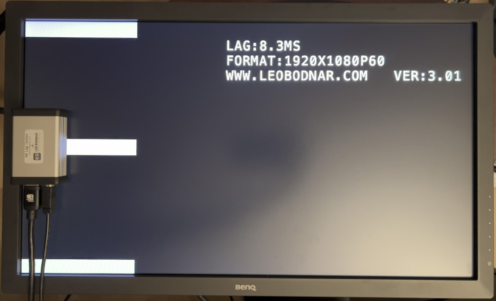 Photo of the Leo Bodnar 4K Lag Tester used with a BenQ gaming monitor.